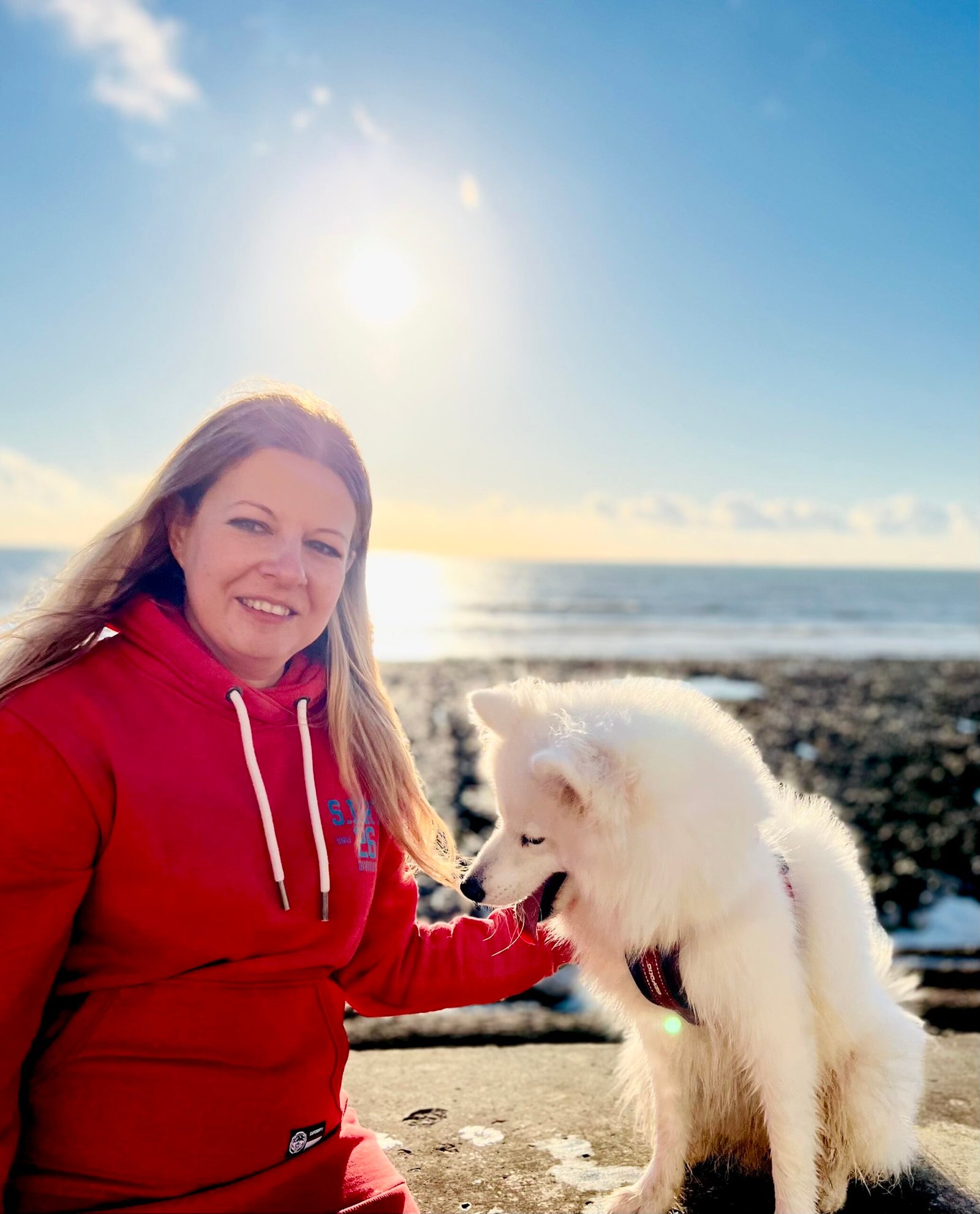 Elena with her dog by the sea